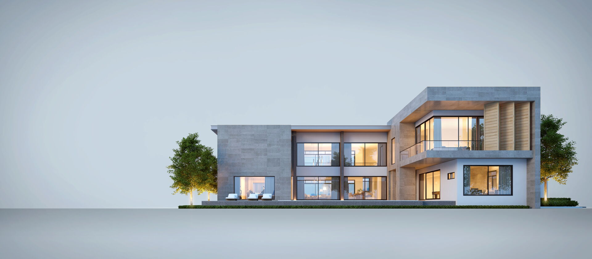 Repräsentatives modernes Haus mit großen Fenstern und beleuchtetem Inneren. Schnitzler Immobilien Lahr.